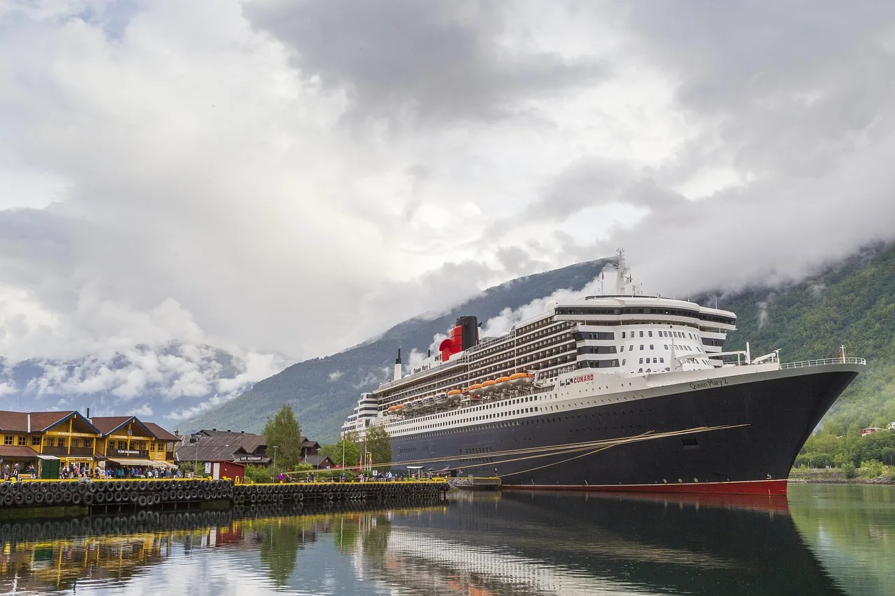 Ocean liner moored beside a mountain harbor
