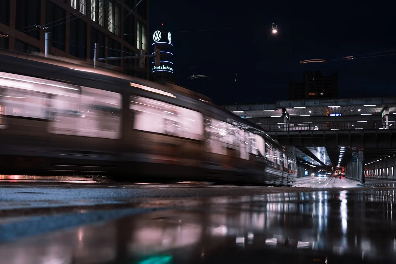 City rail vehicle passing through illuminated streets at night