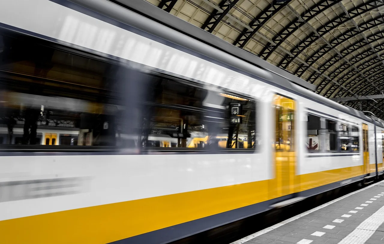 Passenger train passing a covered station platform