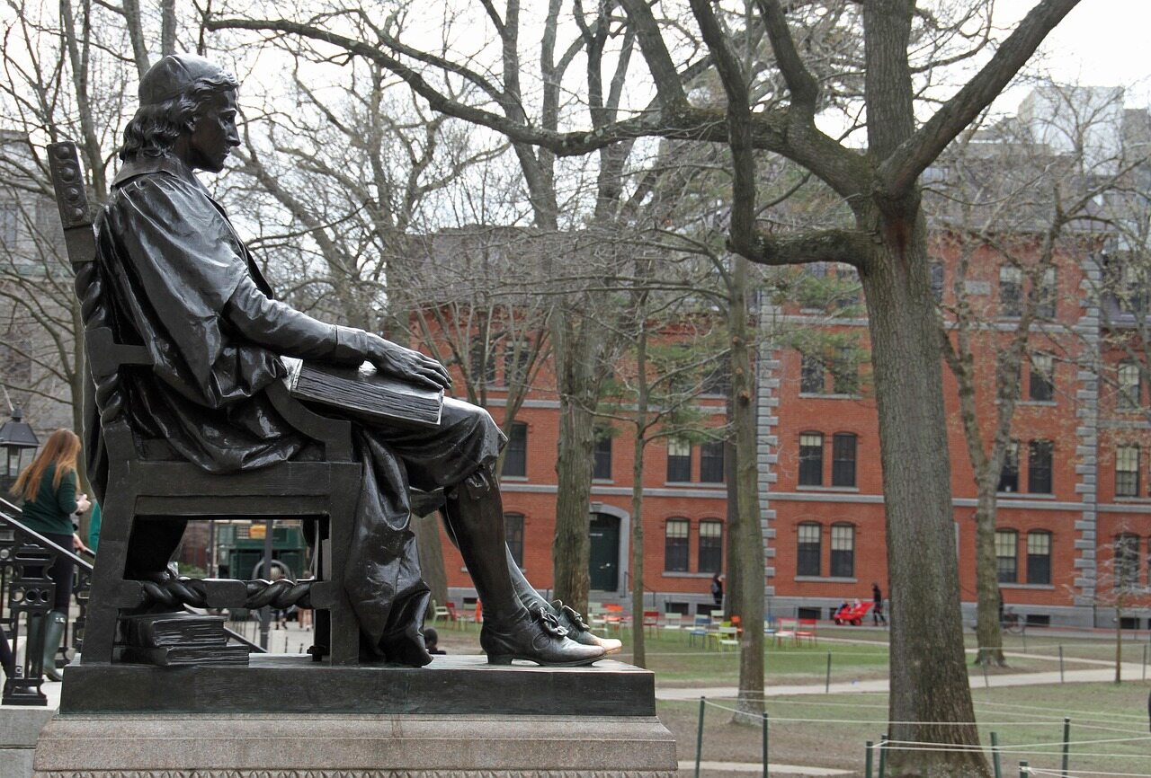 John Harvard statue and red-brick campus buildings at Harvard University